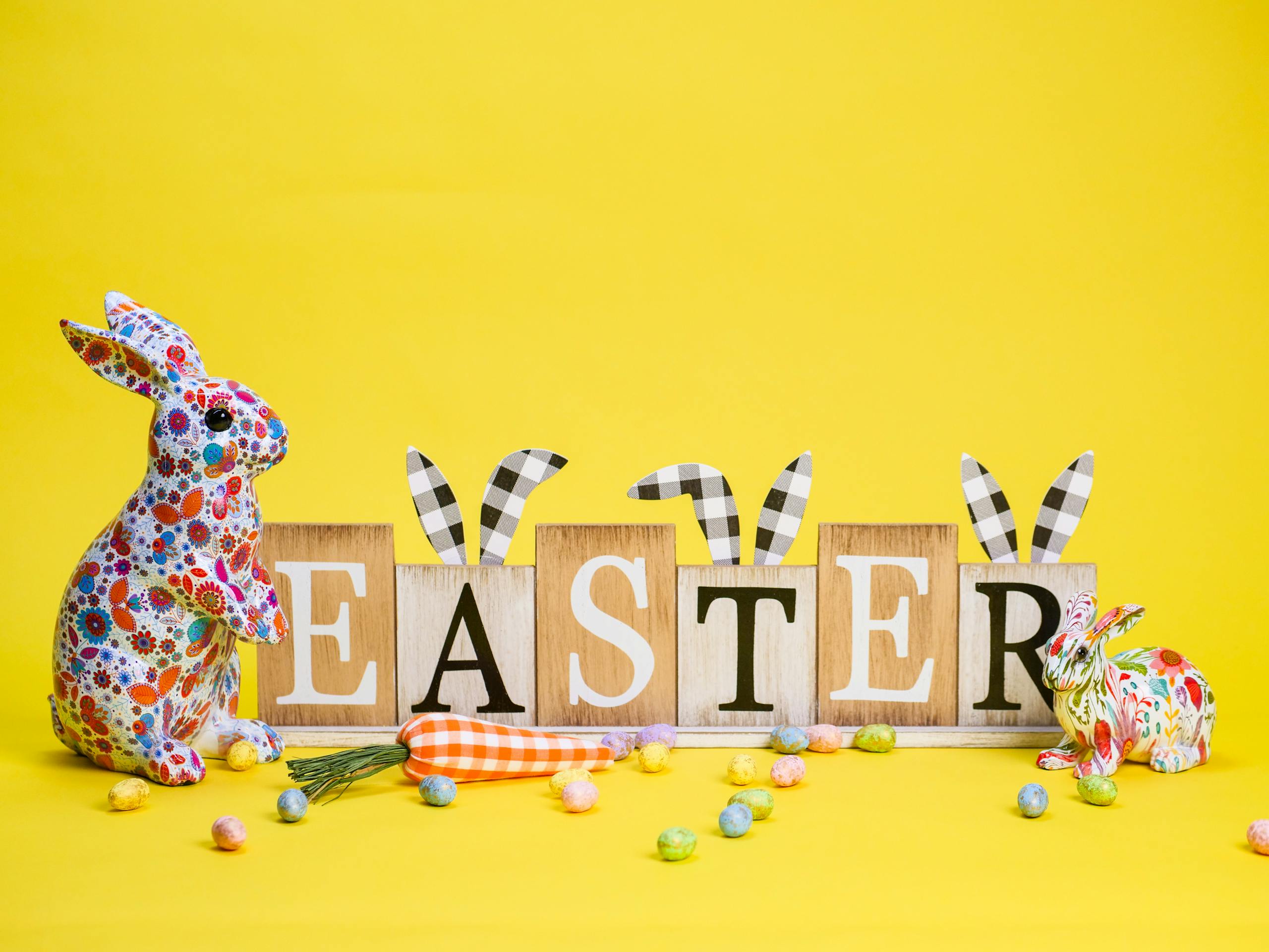 Colorful Easter bunnies and eggs on a bright yellow background create a festive vibe.